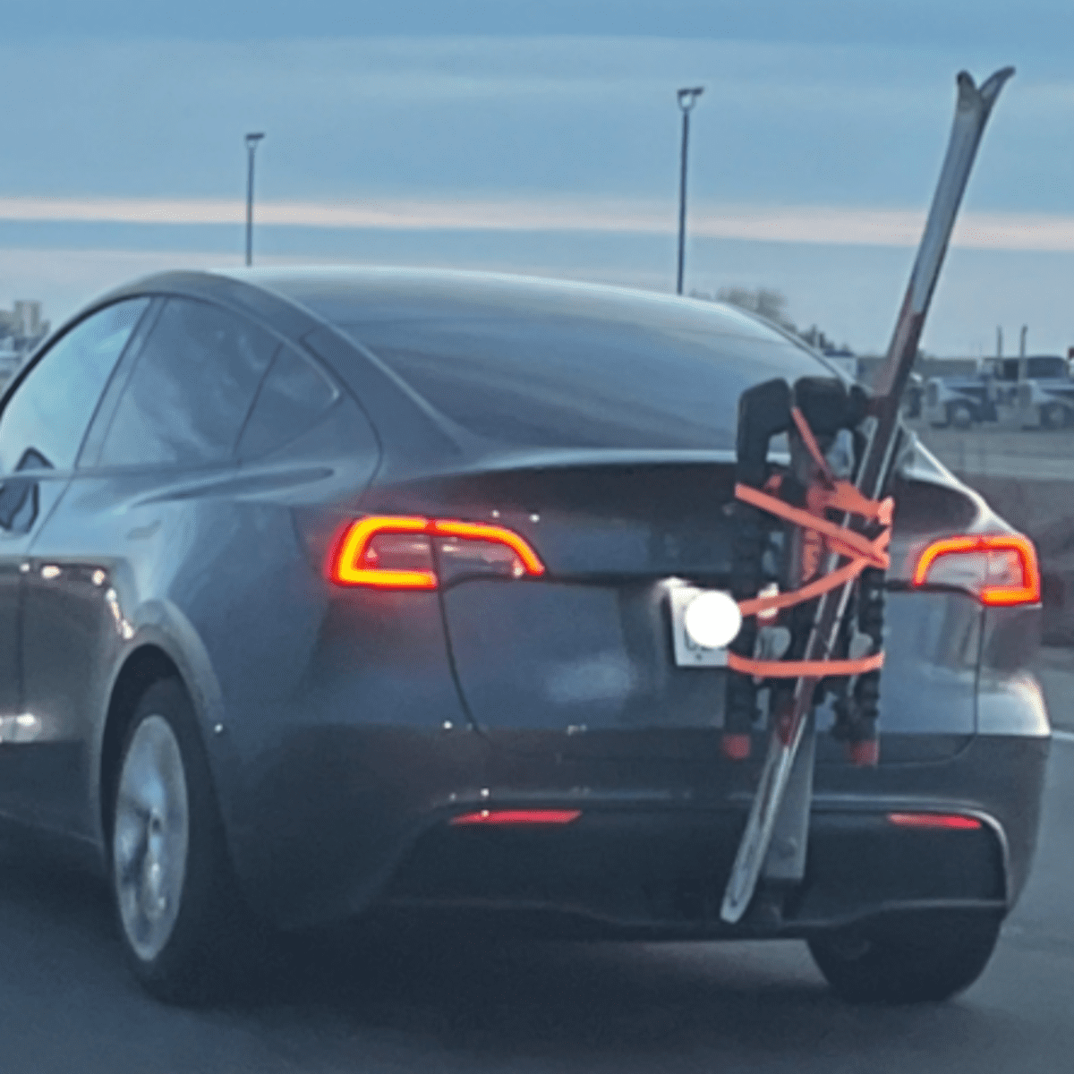 Skis Spotted Hanging Precariously From The Back Of Tesla Powder