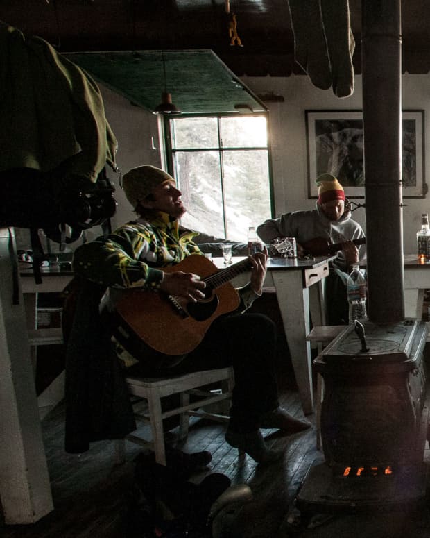 Four skiers hanging out at a mountain hut