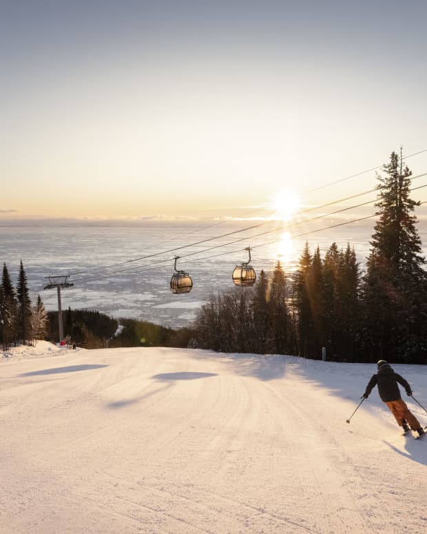 Skiers at sunset at Le Massif de Charlevoix in Quebec, Canada