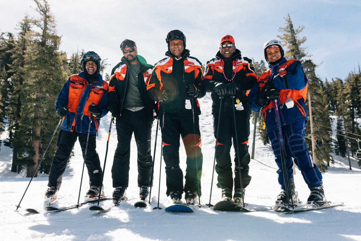 Morgan is wearing a white ski jacket; she's also wearing black ski pants.