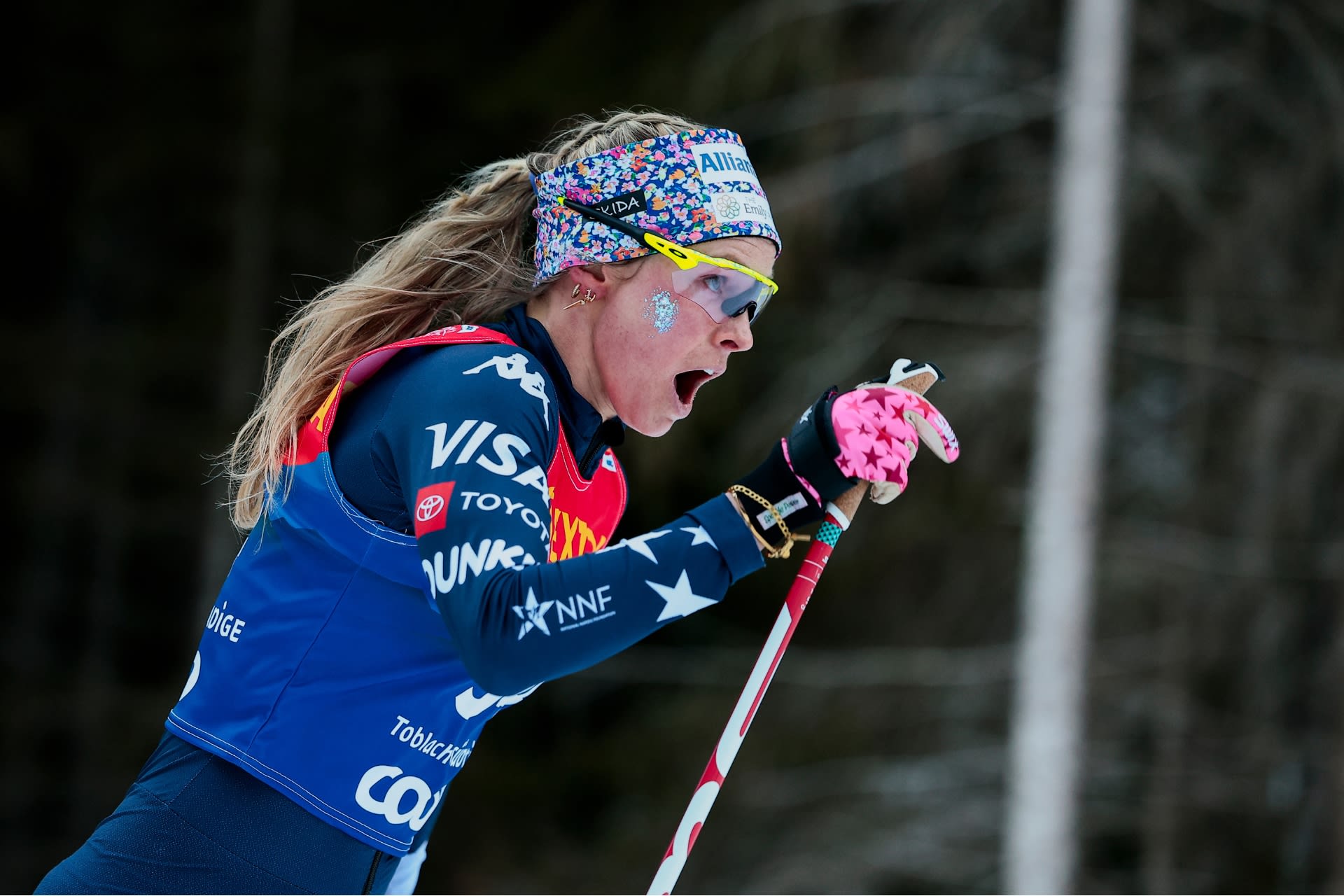 Jessie Diggins pushing hard in the snow during a 2026 cross-country ski race, highlighting her competitive spirit.
