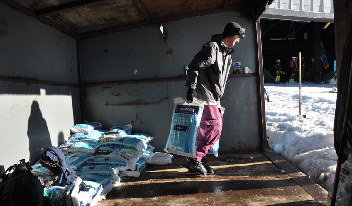 Salt's usage is controversial, but it is the secret ingredient that keeps lift-accessed summer skiing on Mount Hood alive. Alec Nelson hefts two 40-pound bags. PHOTO: Ethan Stone
